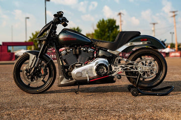 2025 Harley-Davidson Low Rider S custom with carbon fiber fairing and chain-drive swingarm, left side profile